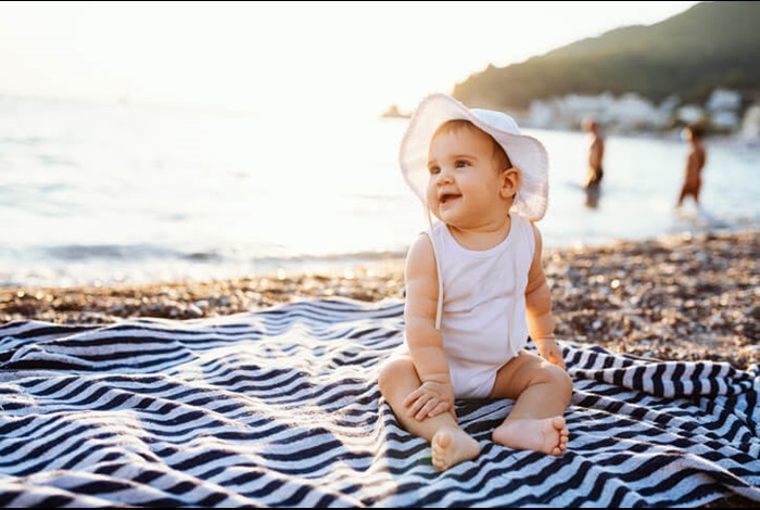 baby at beach sunny