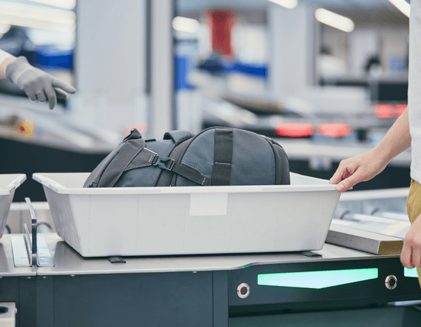 Bin with travel bag passing security check at airport
