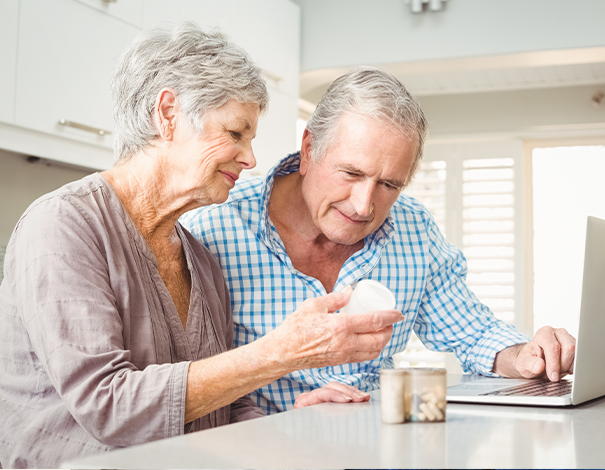 Elderly man and woman studying vitamin bottle